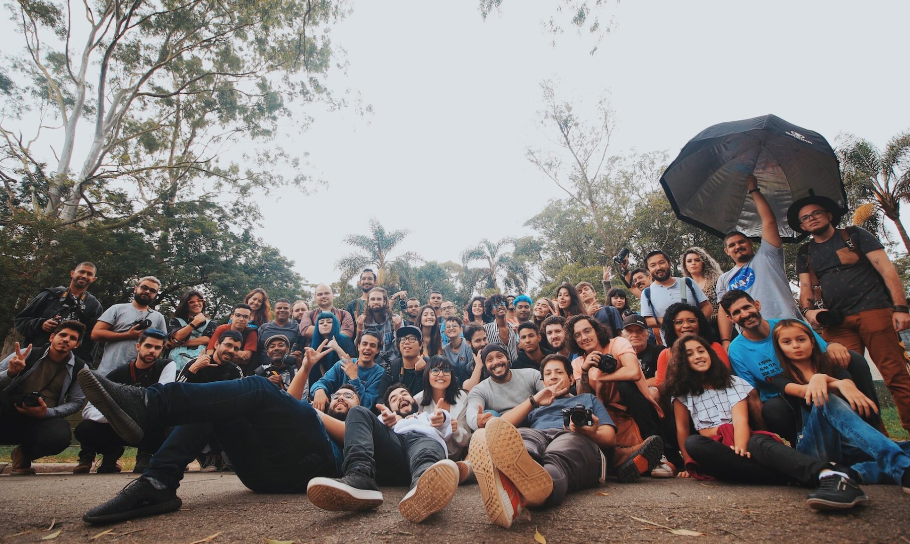 A group of people sitting on the ground together